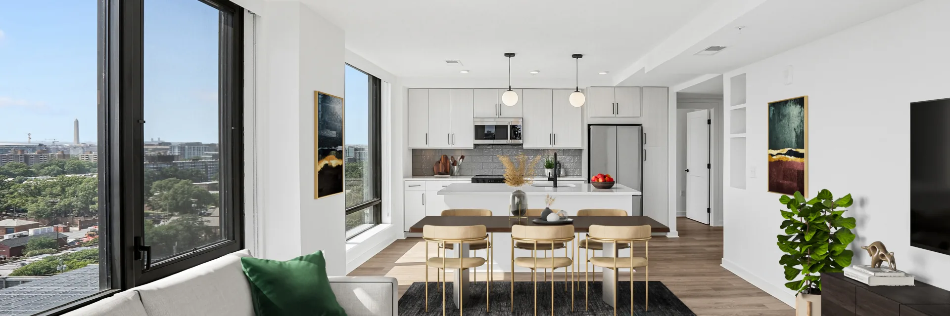 Open-concept living, dining, and kitchen area with expansive city views